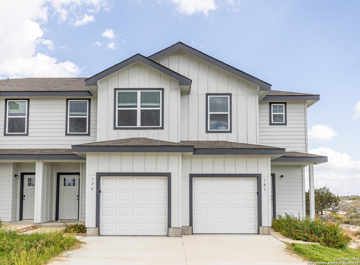 a front view of a house with garage