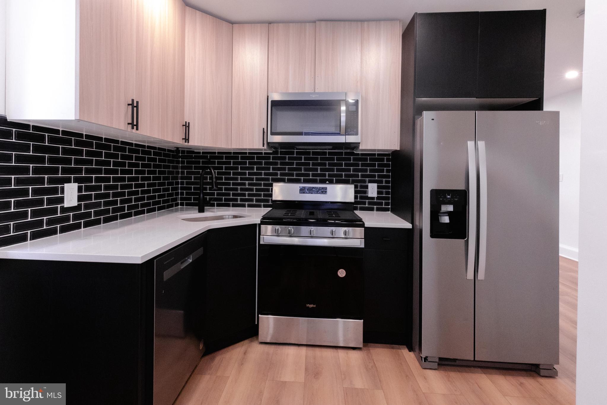 a kitchen with a sink and a refrigerator