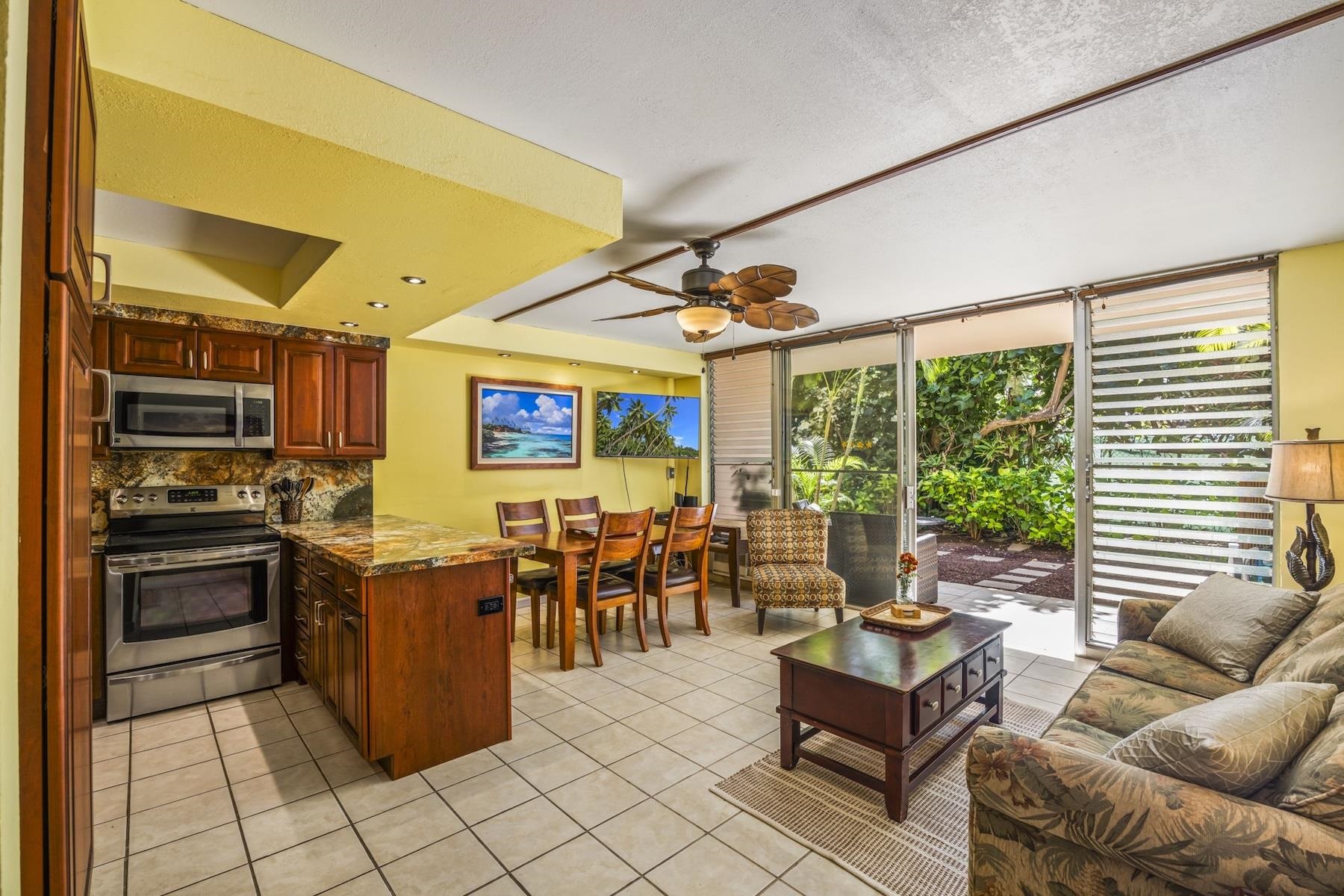 a living room with lots of furniture and kitchen view