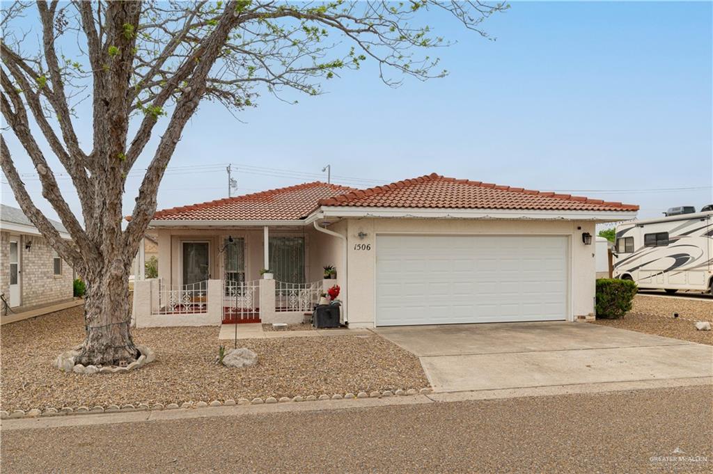 View of front of home with covered porch and a garage