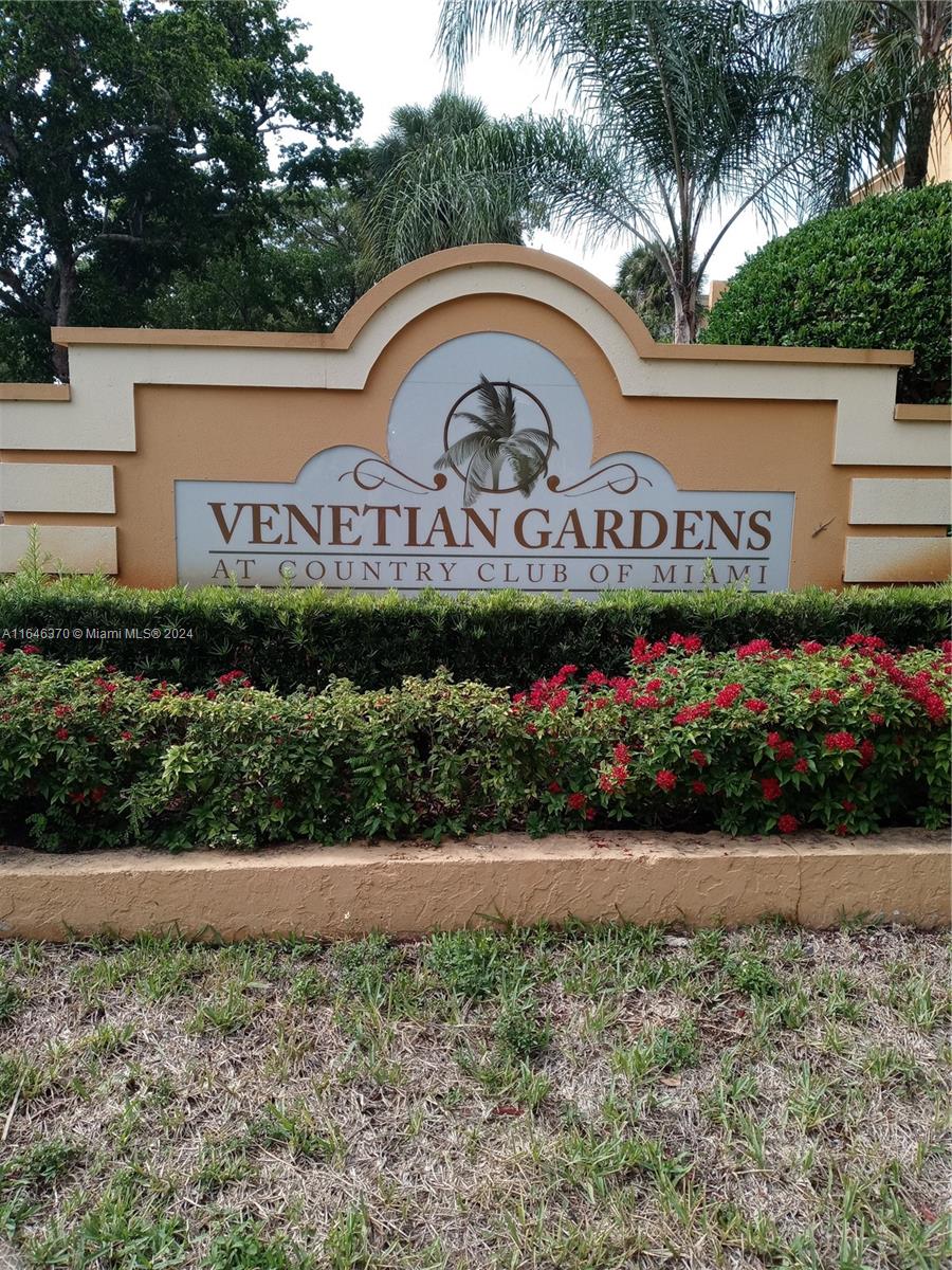 a view of sign board with flower pots