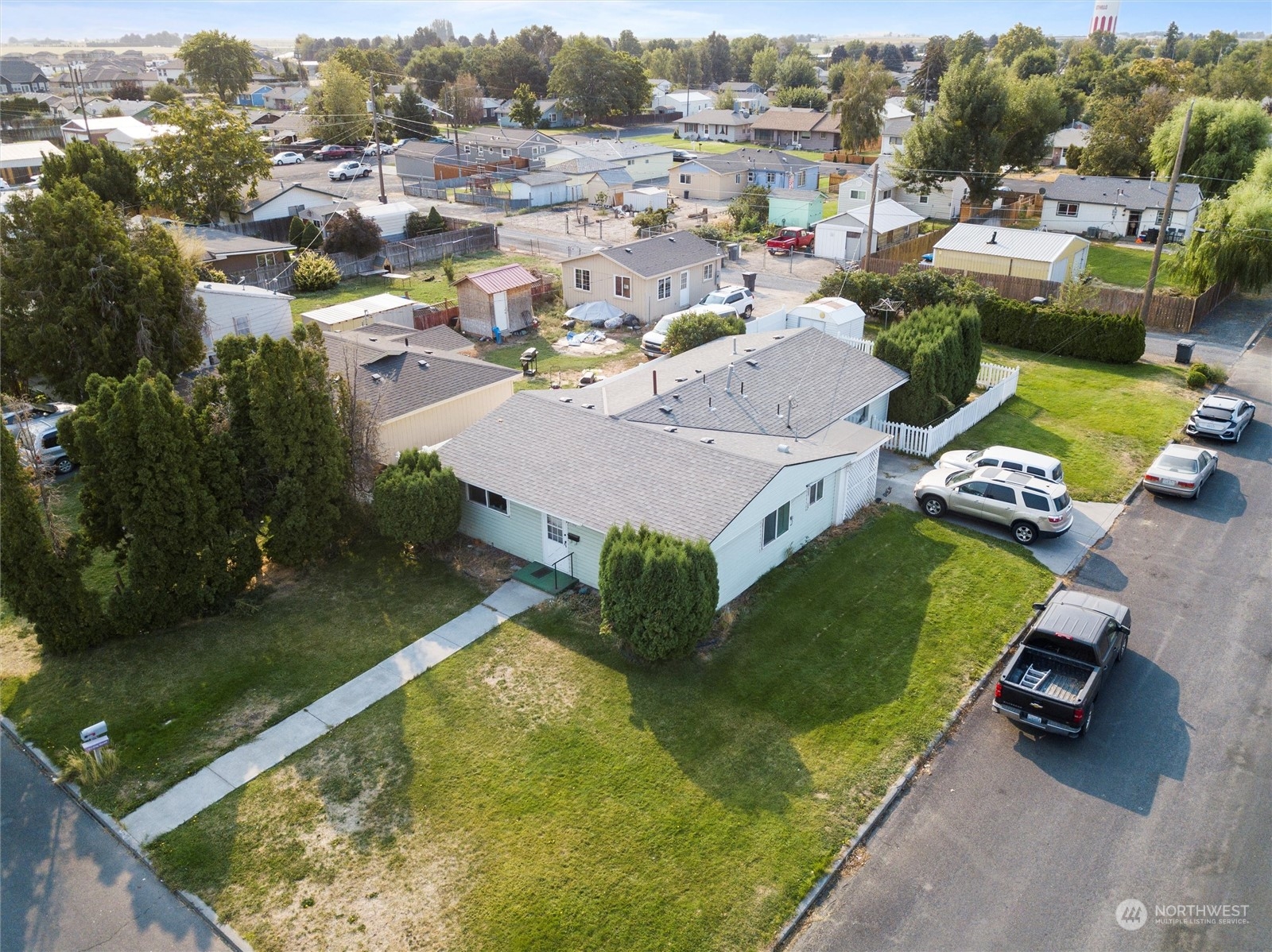 an aerial view of a house with a garden and lake view