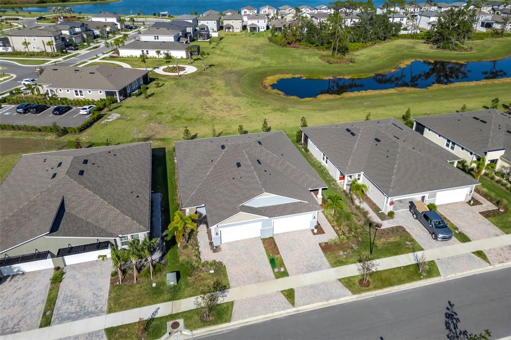 an aerial view of residential houses with outdoor space and street view