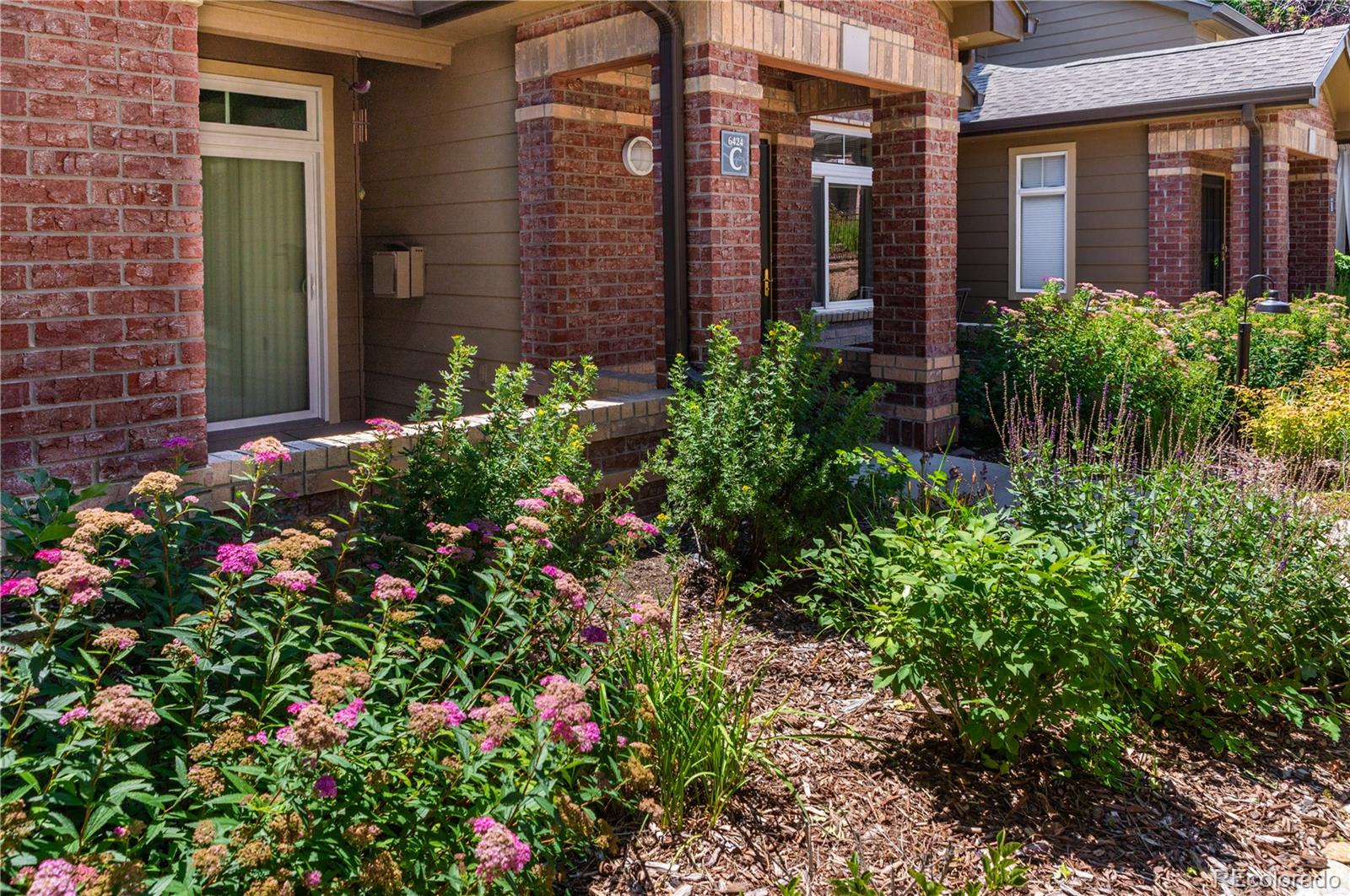 a view of a potted plants on a brick house