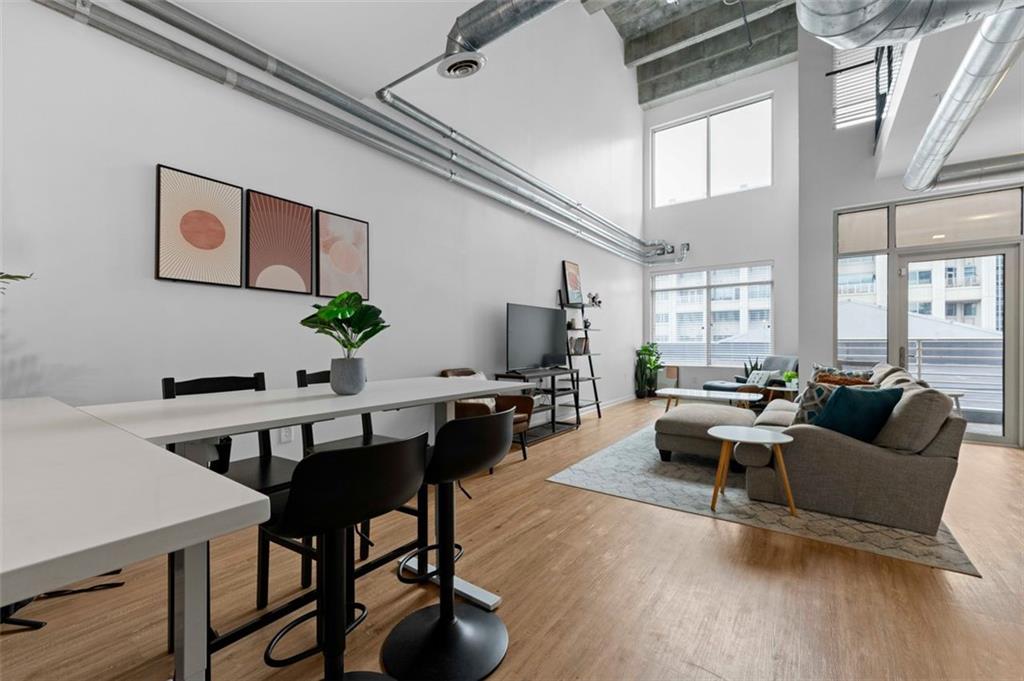 a living room with furniture wooden floor and a window