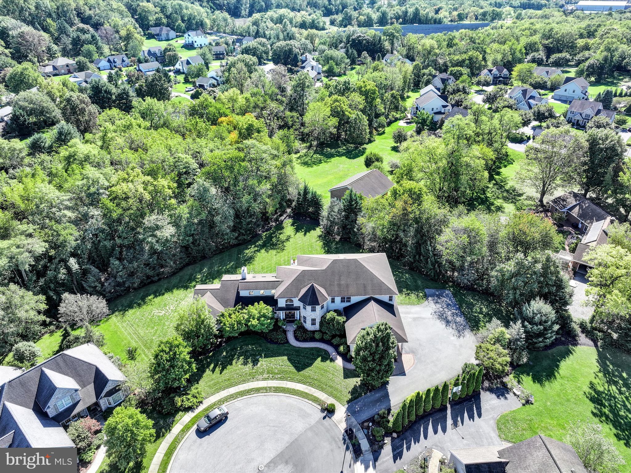 an aerial view of a house with yard swimming pool and outdoor seating