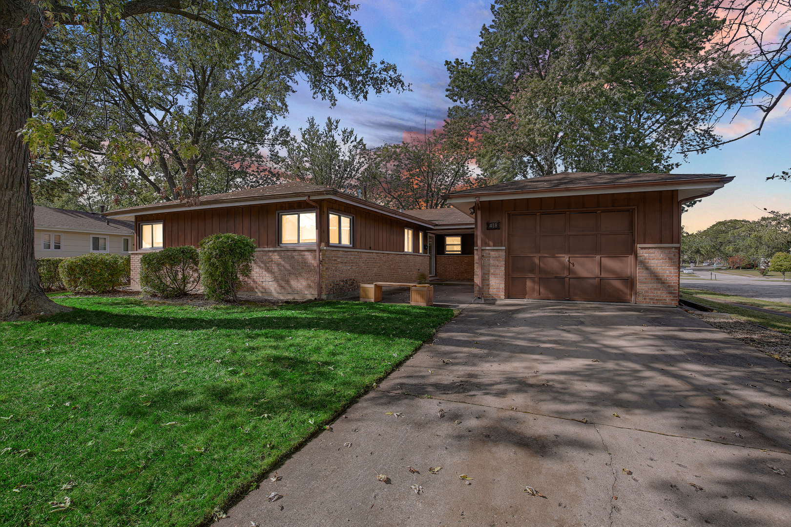 a front view of house with yard and green space