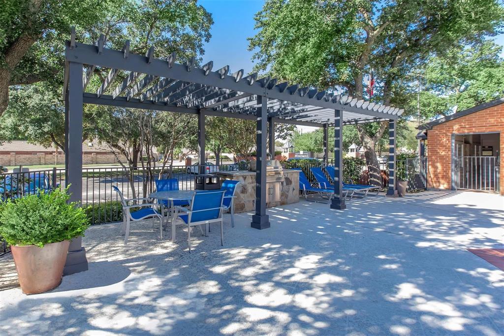 a view of a patio with chairs and potted plants