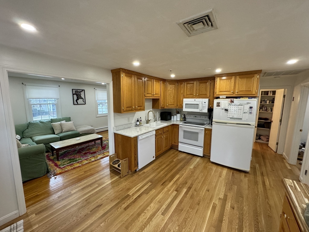 a kitchen with a refrigerator and a stove top oven