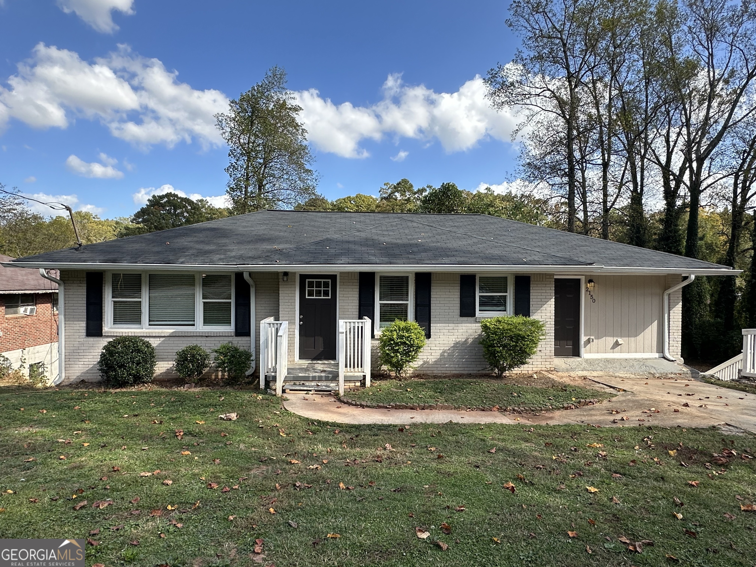 a front view of a house with a yard and porch