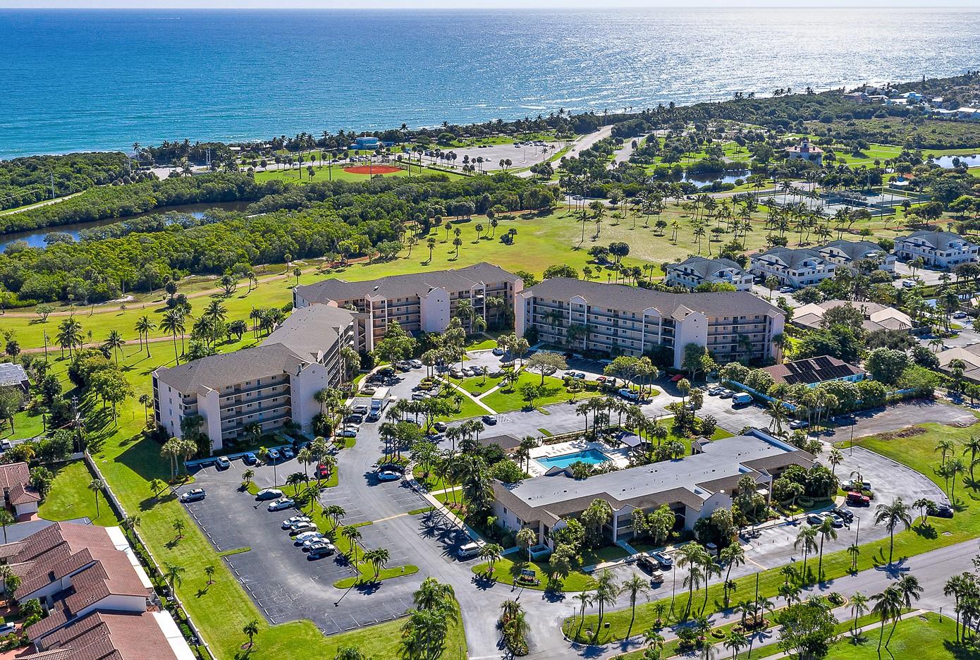 an aerial view of residential houses with outdoor space and swimming pool