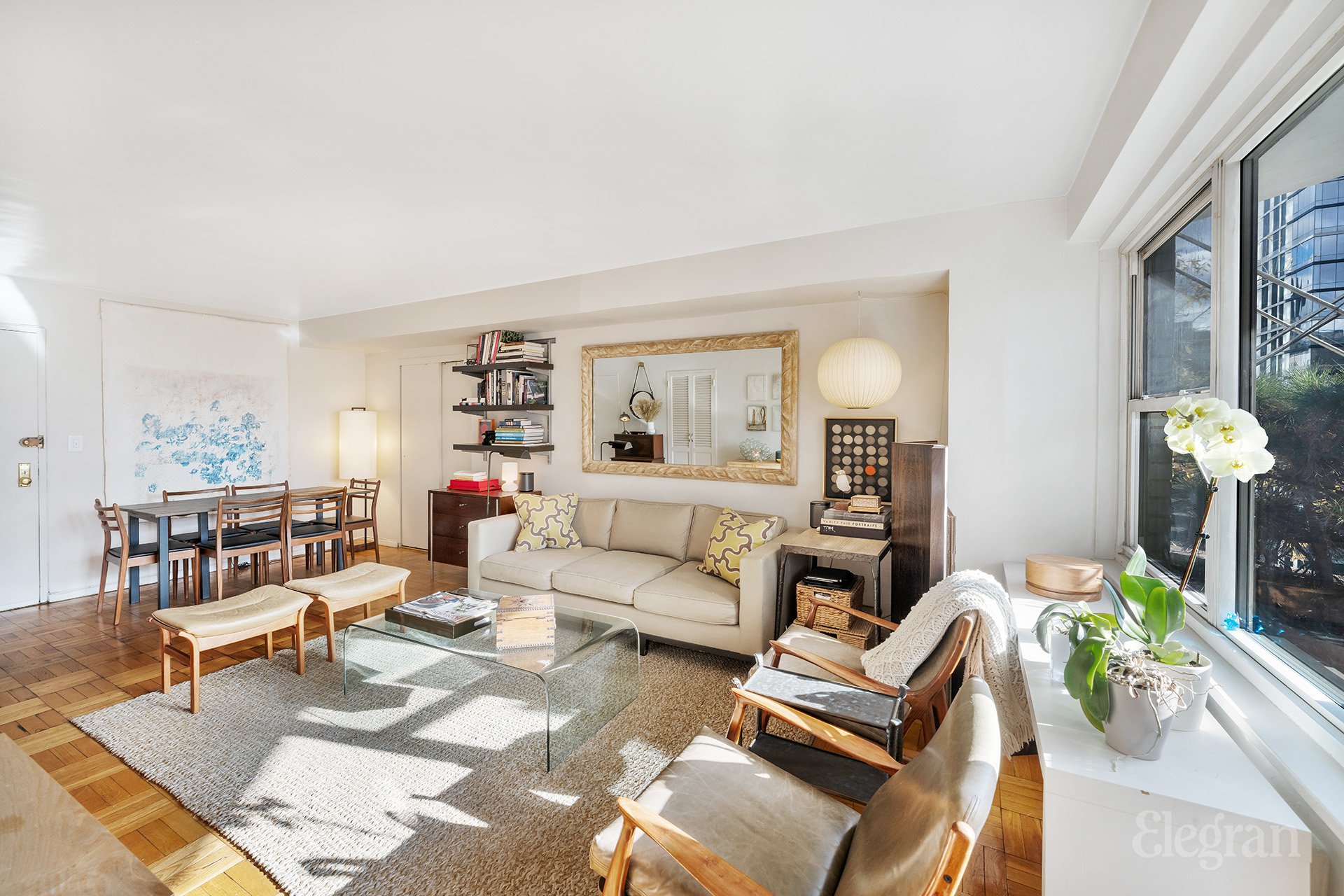 a living room with furniture and wooden floor