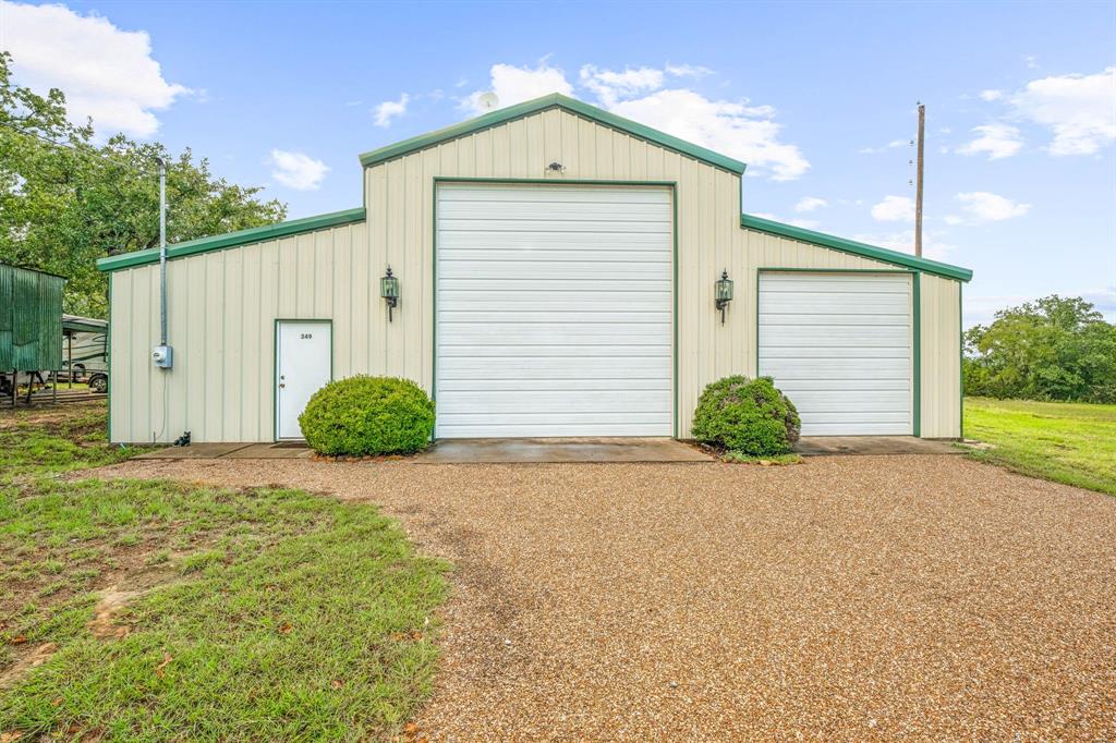 a view of a house with a yard and garage