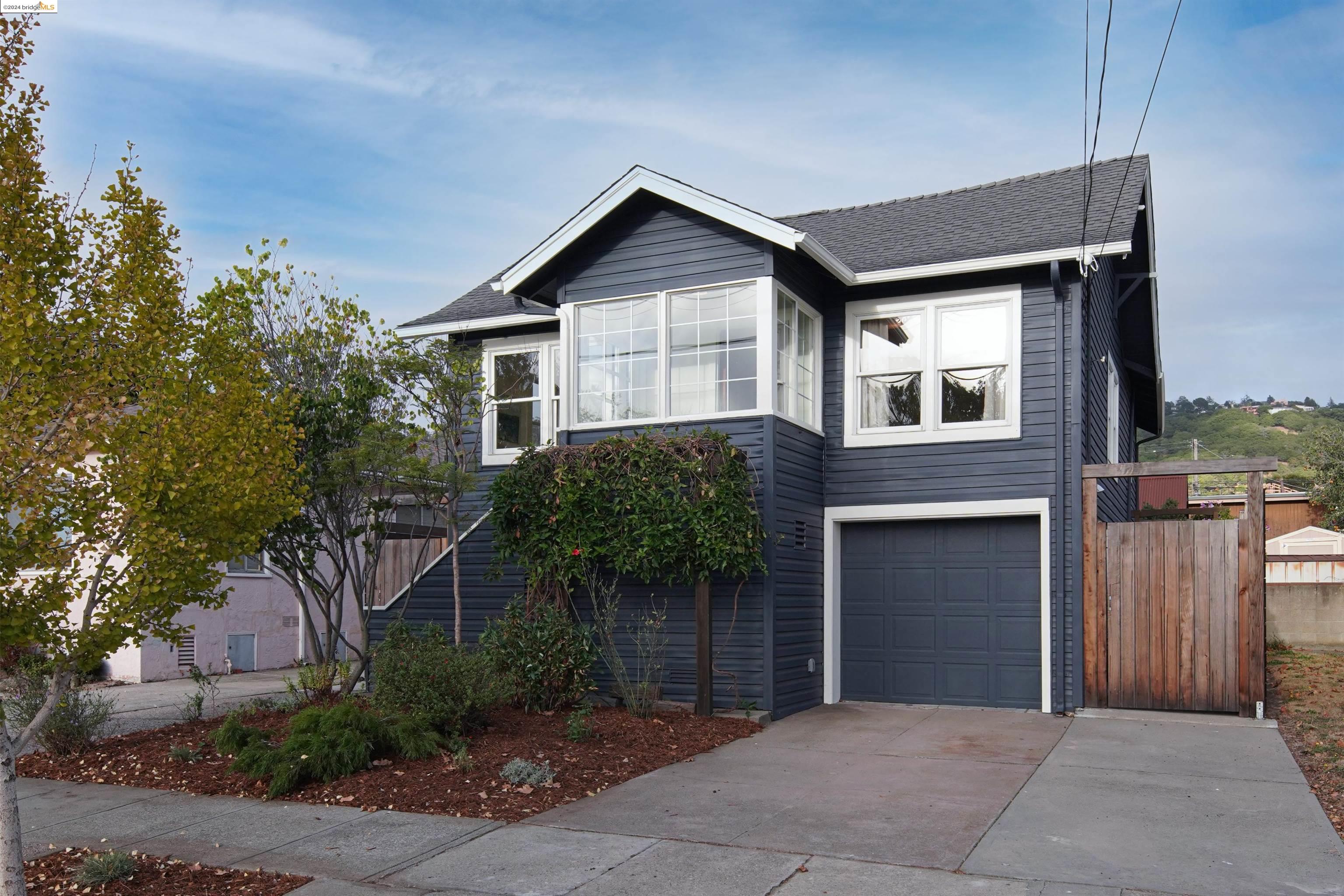 a front view of a house with a garden