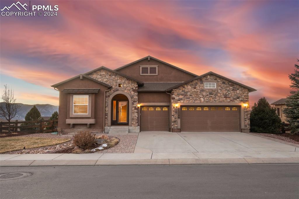 View of front of home featuring a mountain view and a 3 car garage