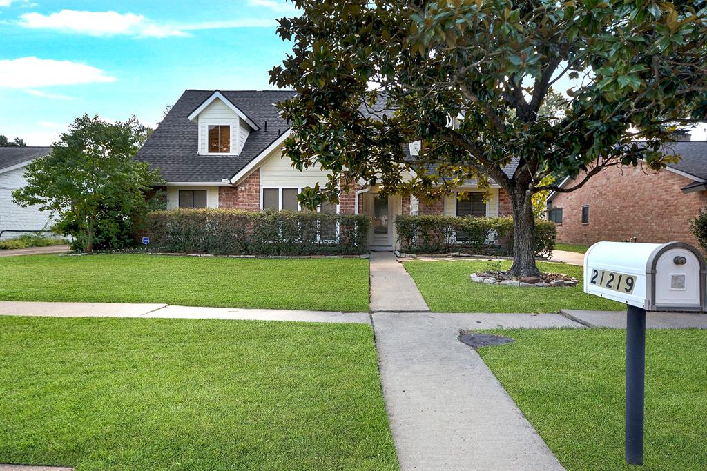 a front view of a house with yard