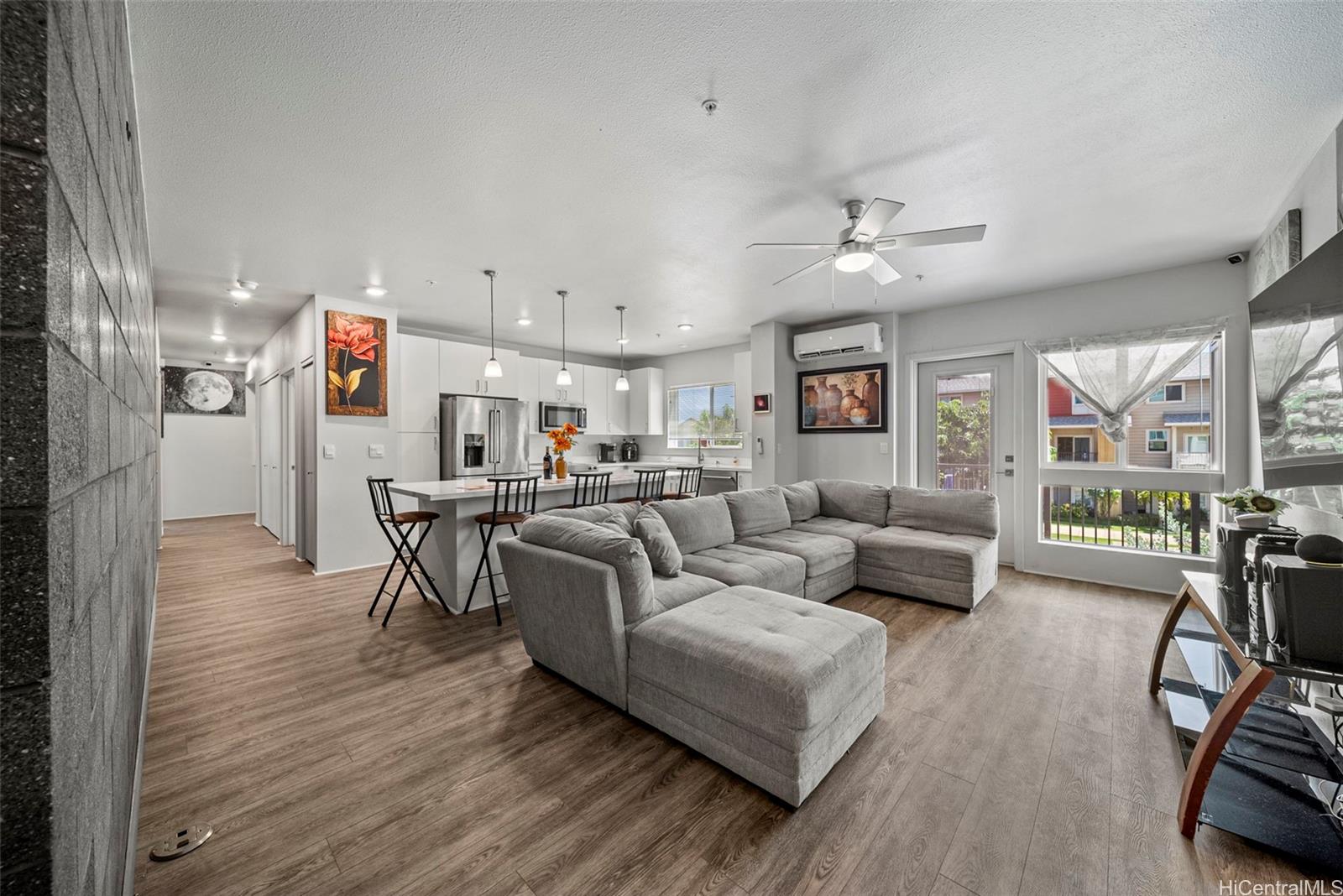 a living room with furniture and a wooden floor