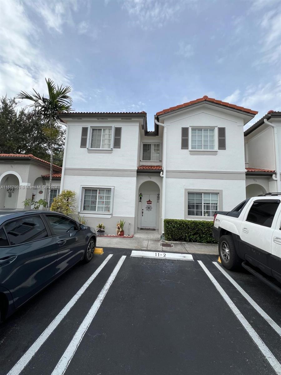 a view of a car park in front of house