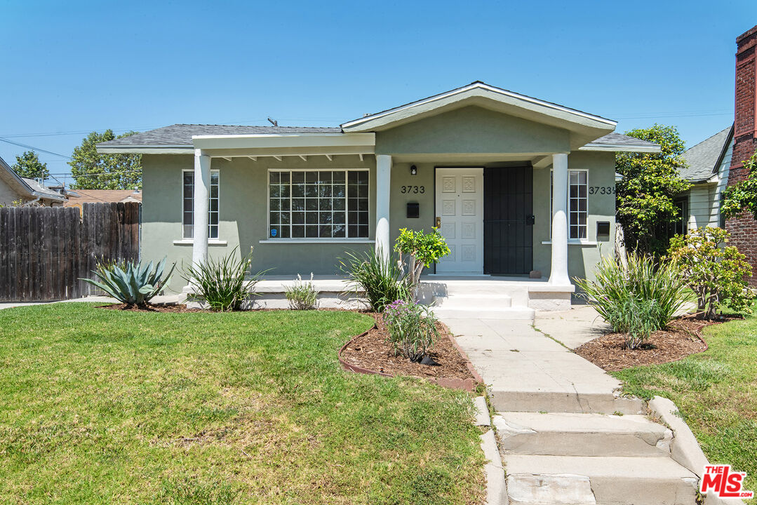 a front view of a house with a yard and porch