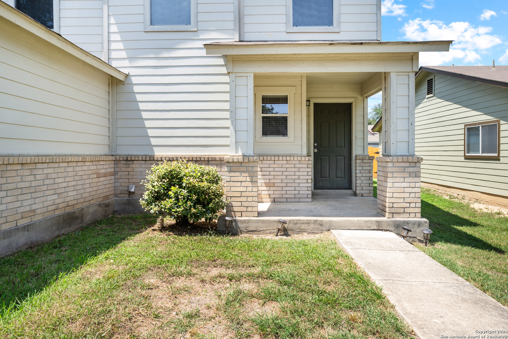 a front view of a house with a yard