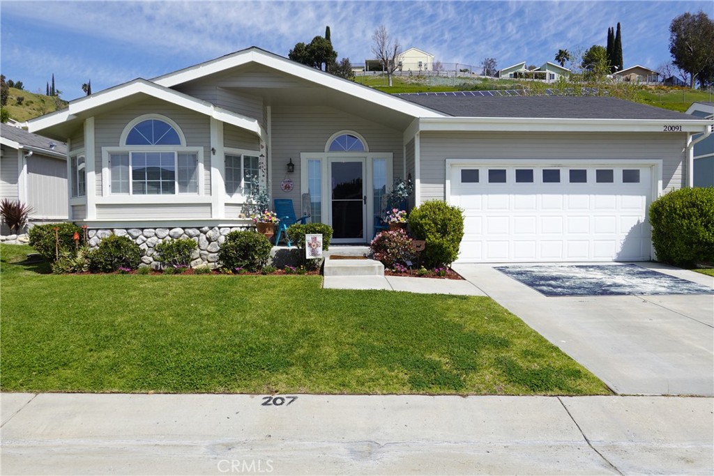 a front view of a house with a garden