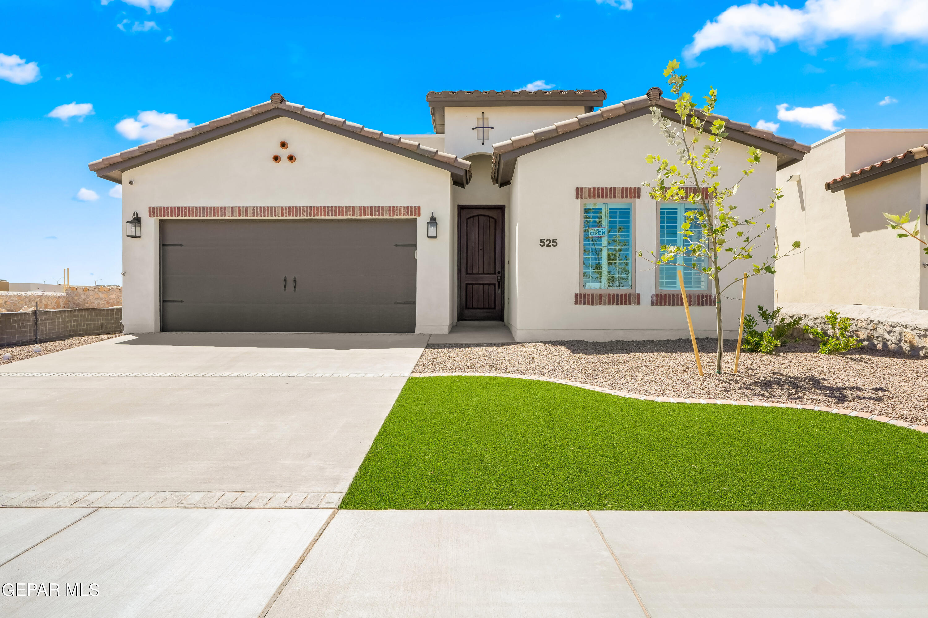 a front view of a house with a yard