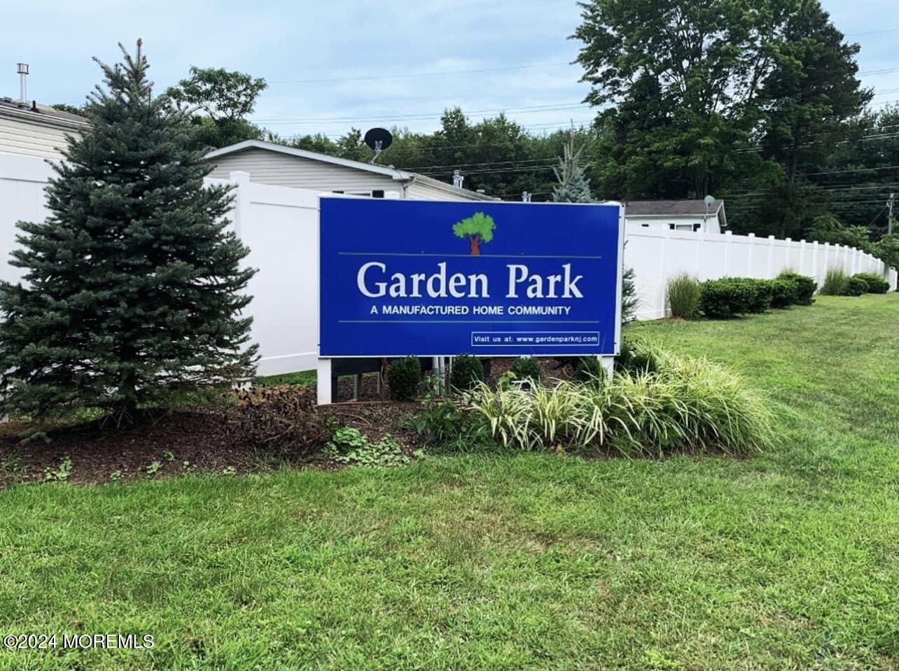 a sign that is sitting in the grass next to a road