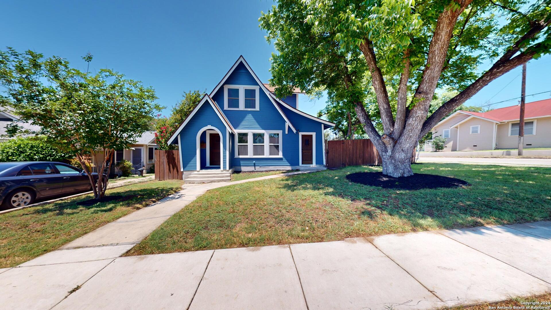 a front view of a house with a garden