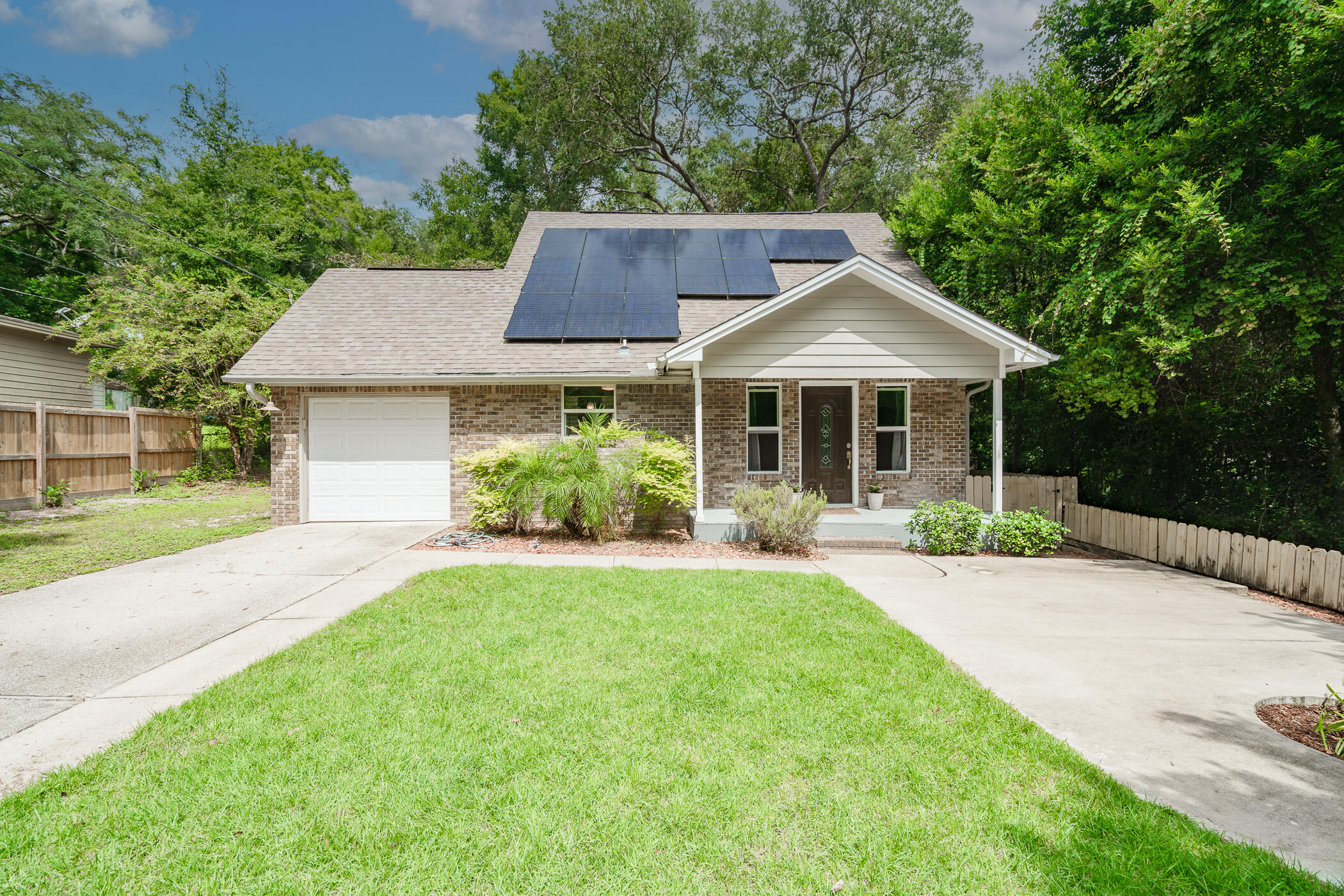 a front view of a house with yard porch and green space