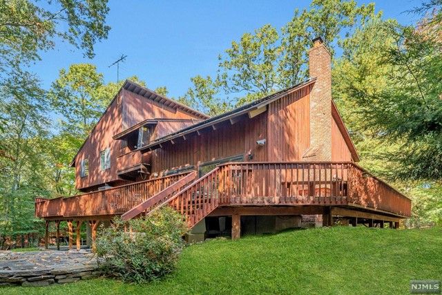 a view of backyard with a garden and deck