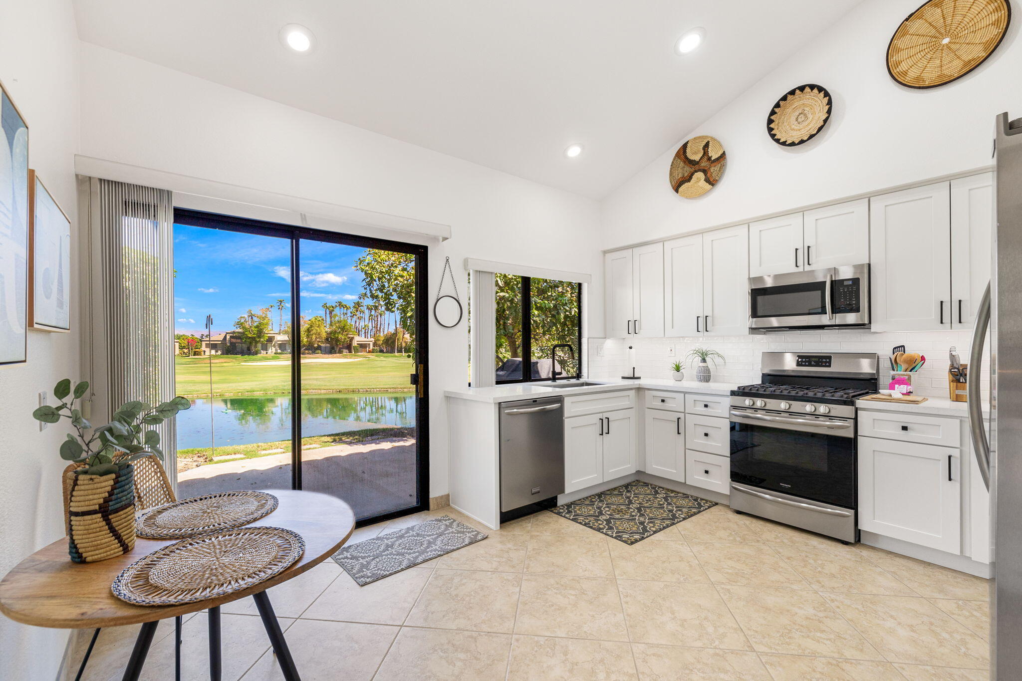 a kitchen with a stove a refrigerator and microwave