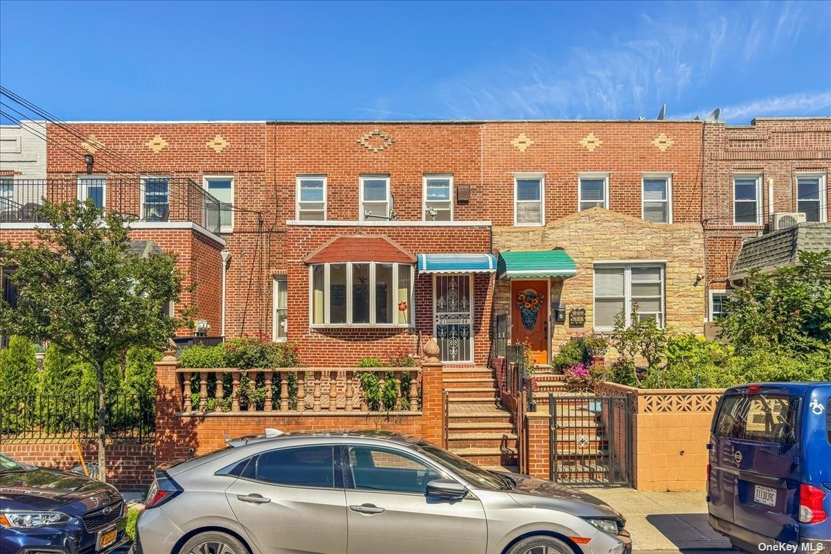 a front view of a residential apartment building with a yard