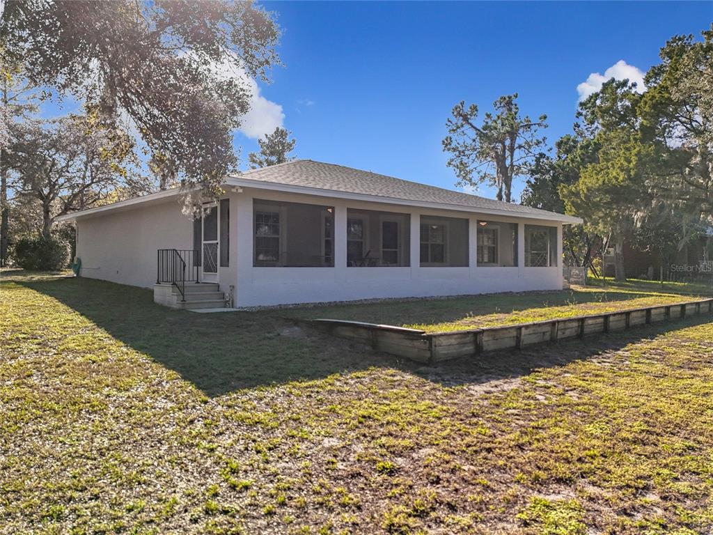 a view of a house with pool and sitting area