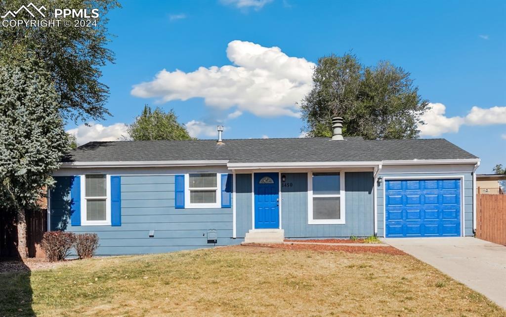 Single story home with a front yard and a garage