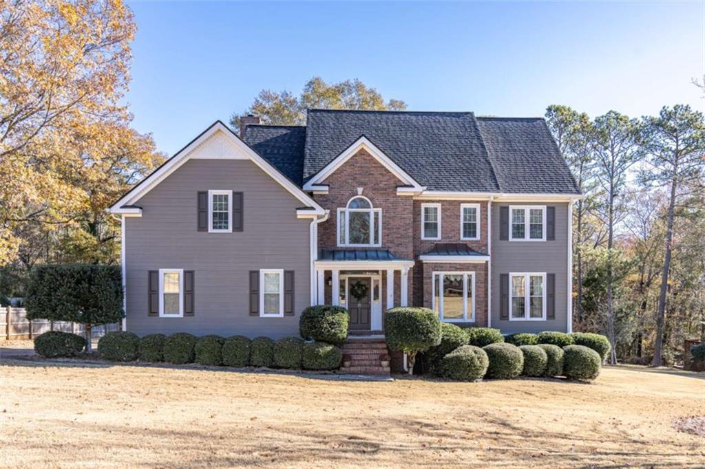 a front view of a house with a yard