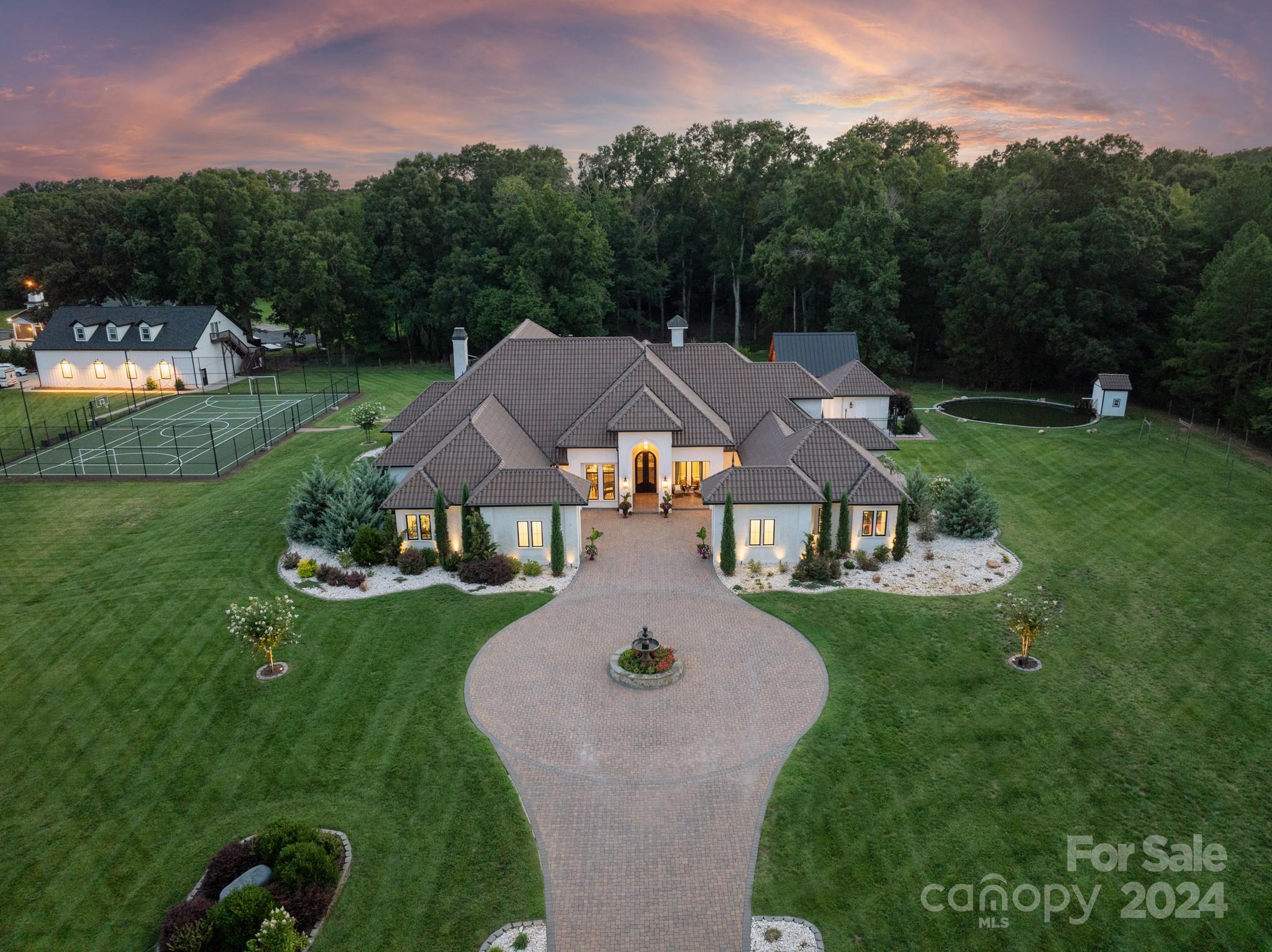 an aerial view of a house with swimming pool and garden