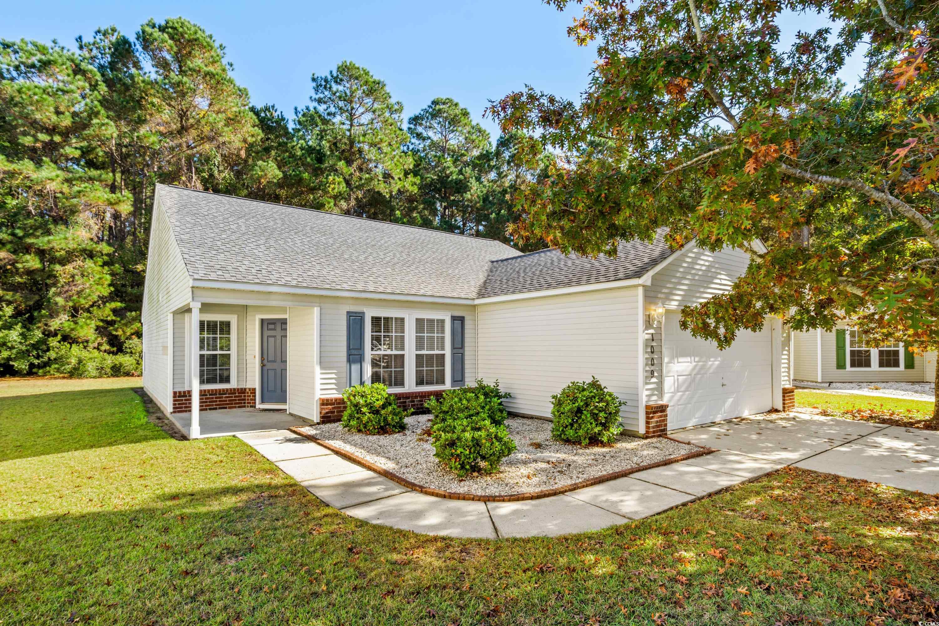 View of front of property with a garage and a fron