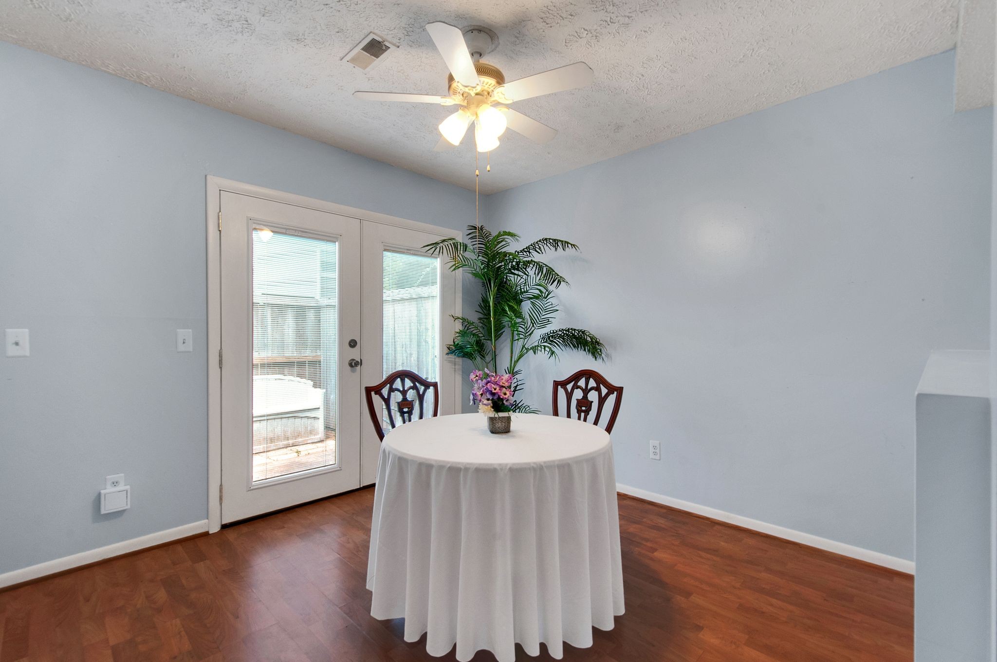 a view of dining room with furniture wooden floor and chandelier