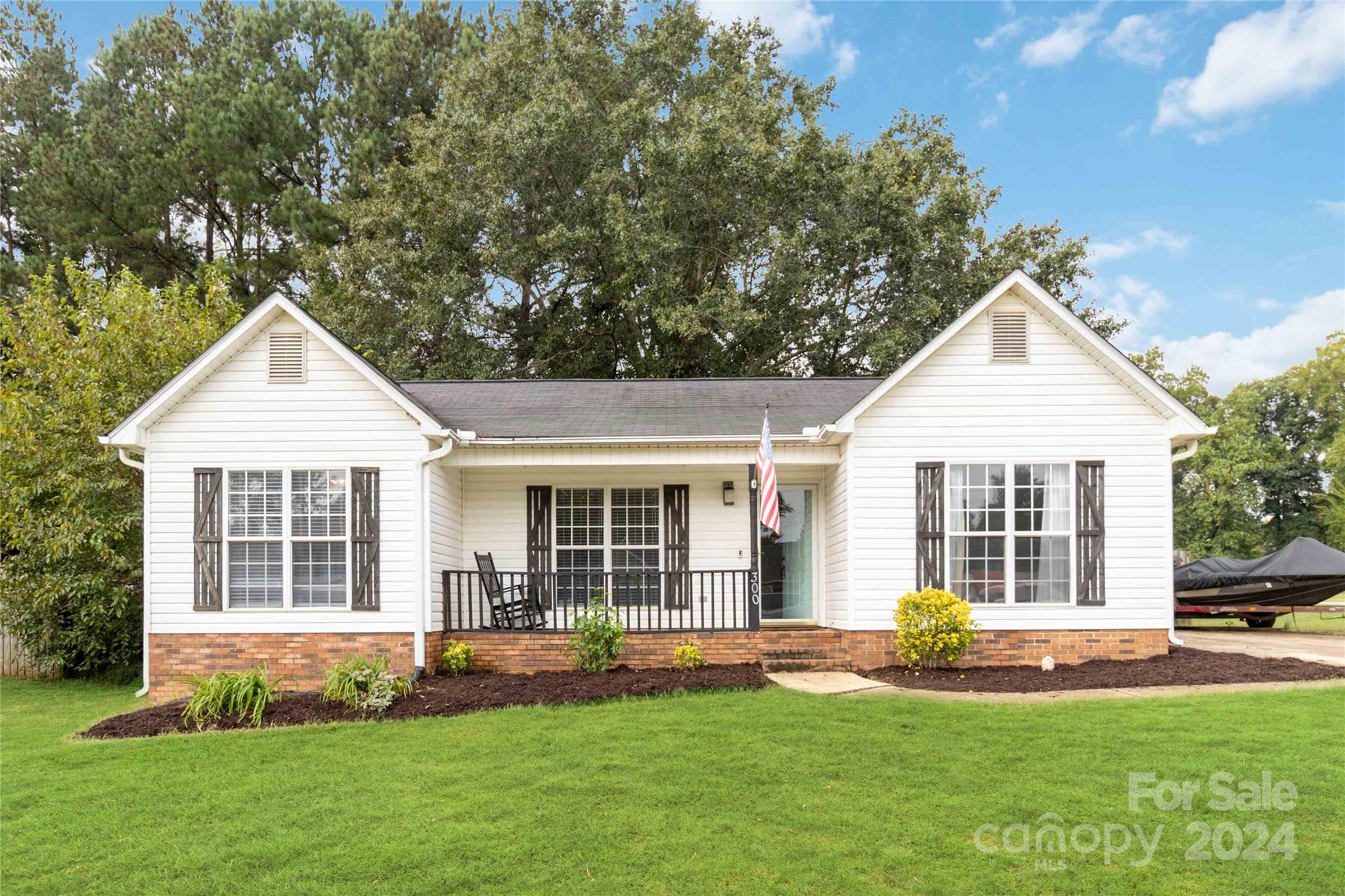 a front view of a house with a yard and porch