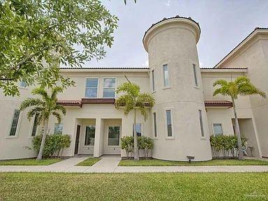 Rear view of property with a lawn