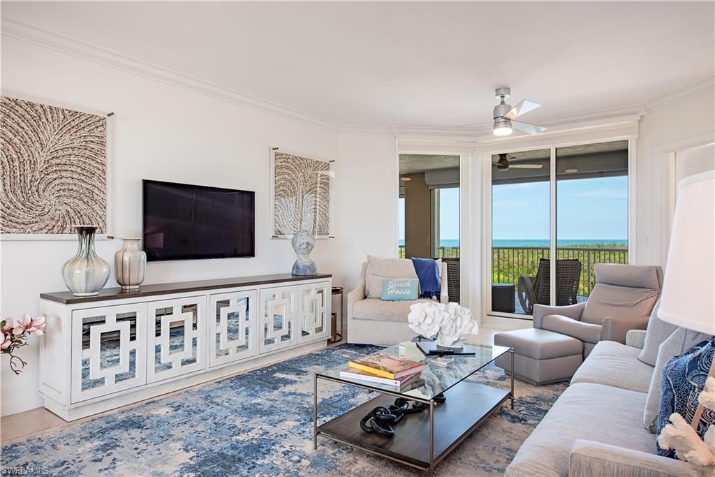 a living room with furniture tv and a window