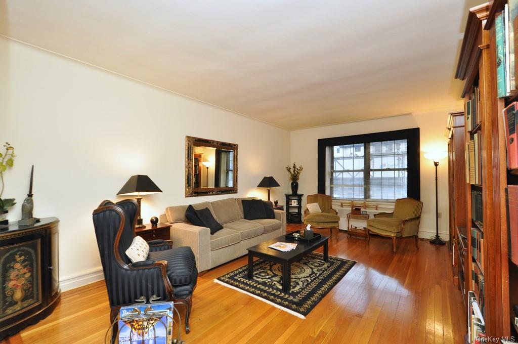 a living room with furniture rug and wooden floor