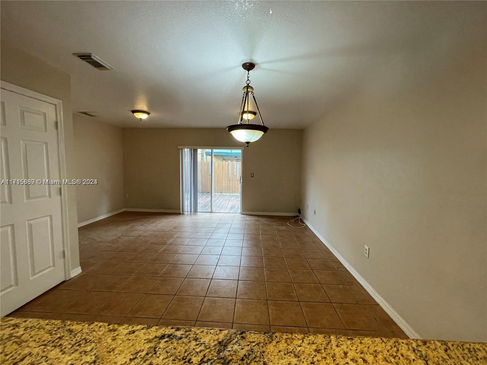 a view of a hallway with a chandelier