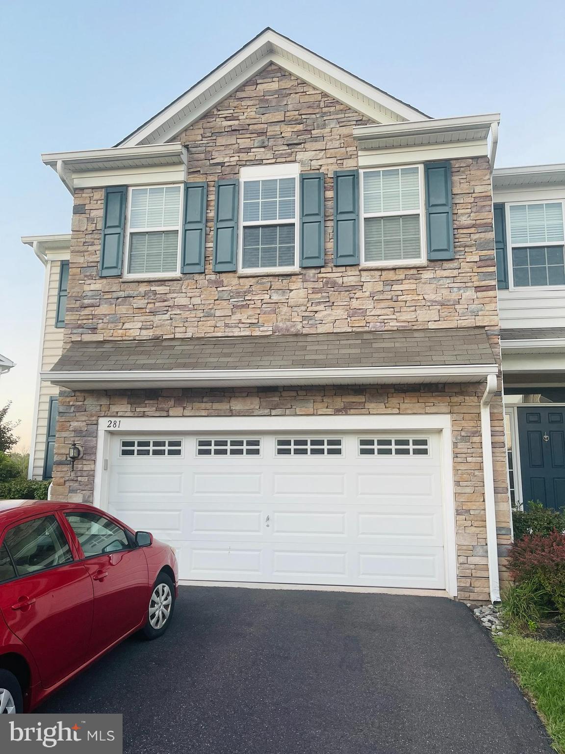 a front view of a house with parking space