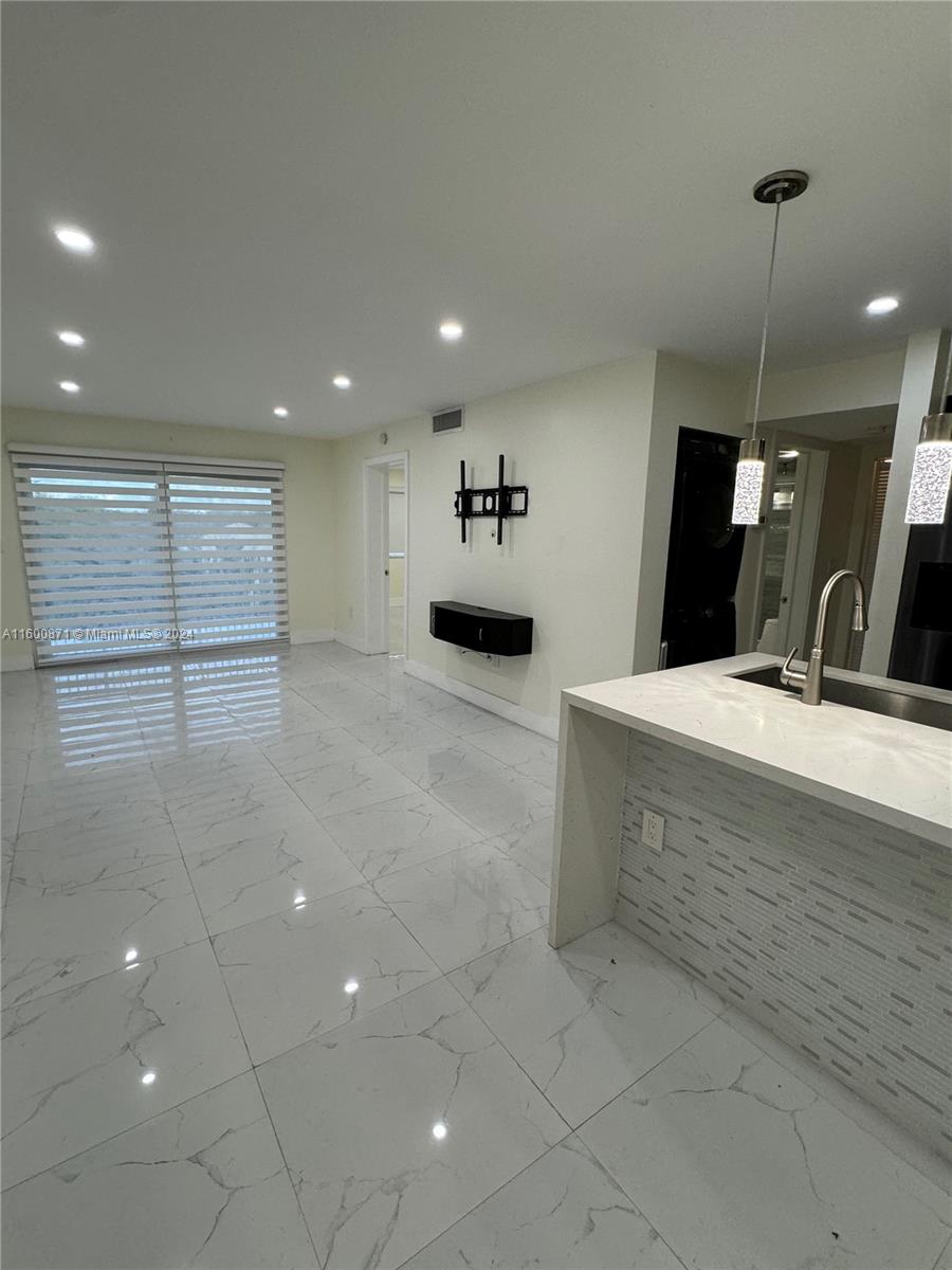 a bathroom with a sink a large mirror and shower