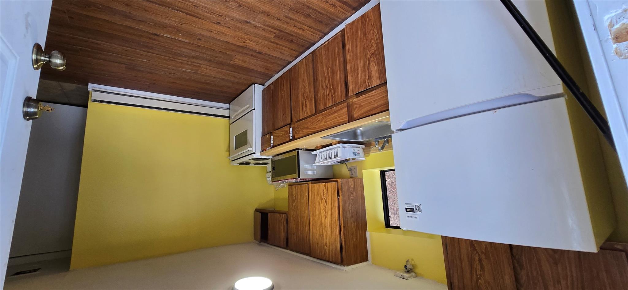 a kitchen with a refrigerator and a stove