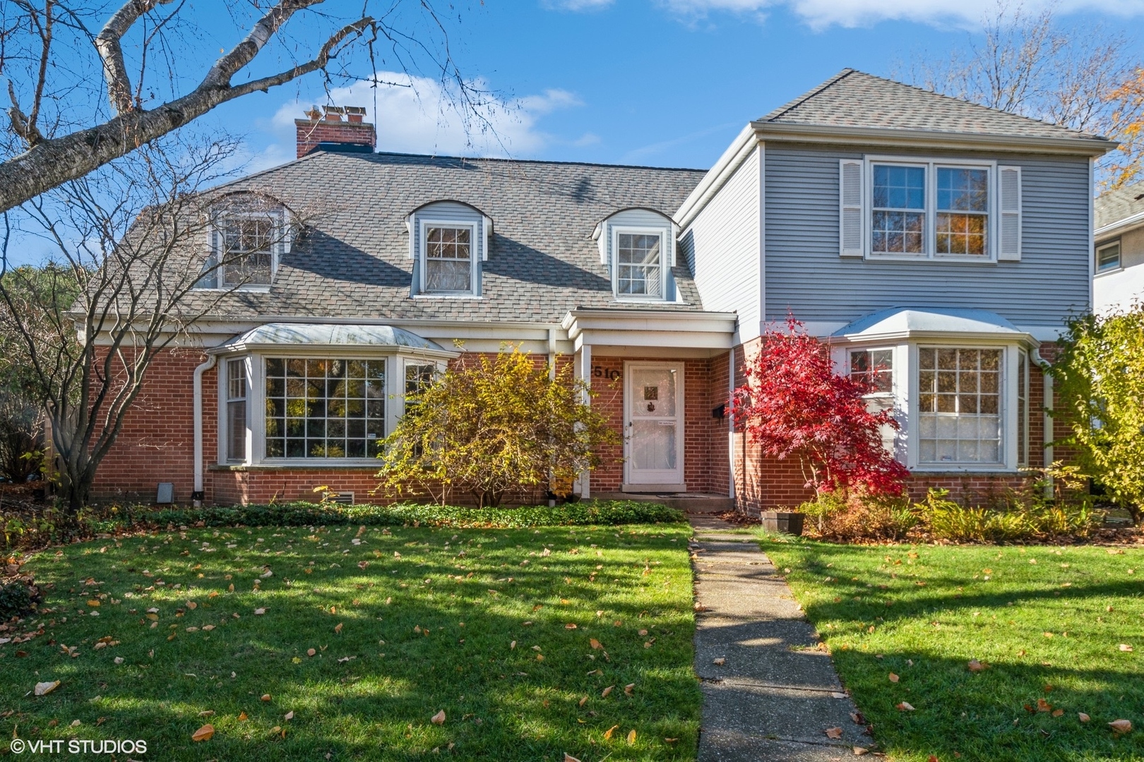 a front view of house with yard and green space