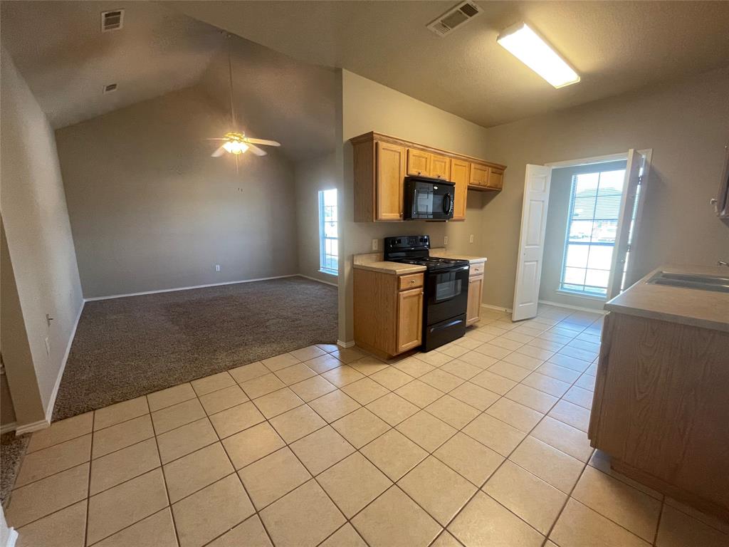 a kitchen with granite countertop a sink and a stove top oven