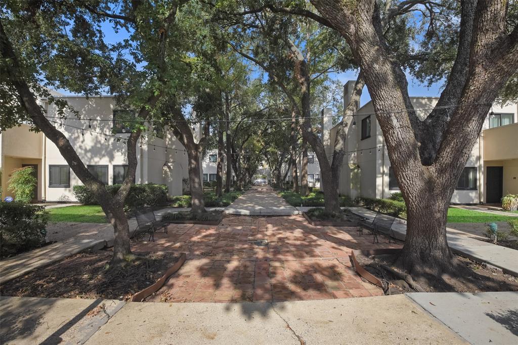 Beautifully maintained complex with mature trees and charming, shaded courtyards with string lights.