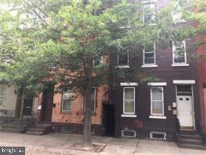 a front view of a house with yard